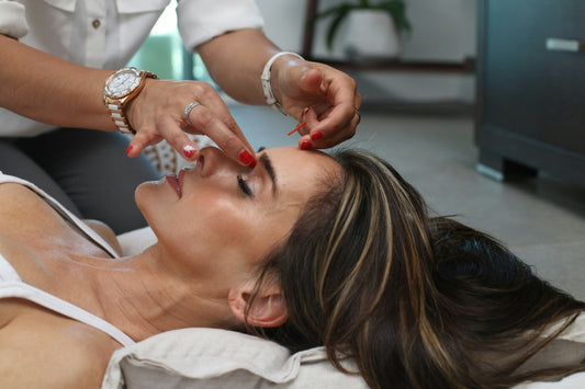 Woman receiving natural anti-aging facial treatment, highlighting Notox techniques like gua sha, facial massage, and holistic skincare