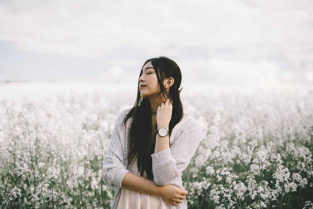 Woman in a field of white flowers