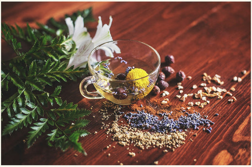 Herbal tea with flowers and leaves on a wooden background