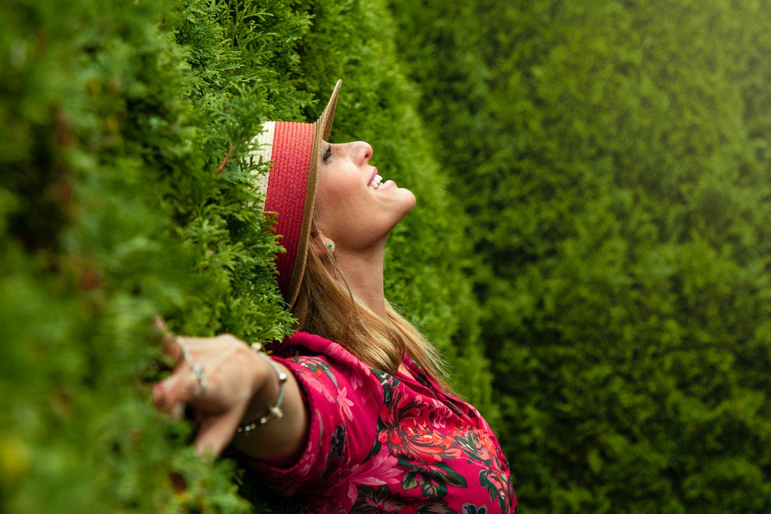 Happy woman laying in a field of grass