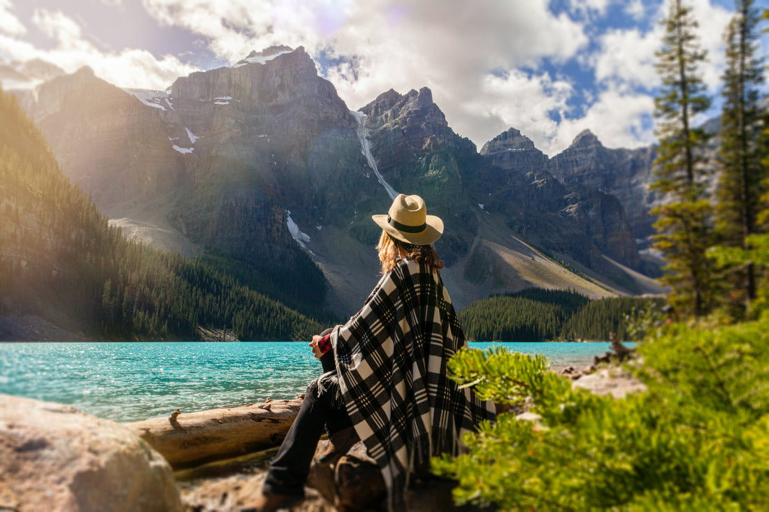 Woman sitting on a rock by a lake