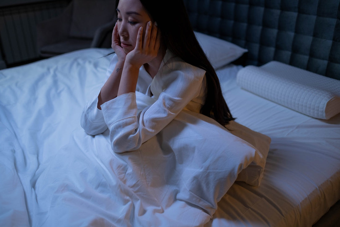 Woman in bed with anxiety and insomnia