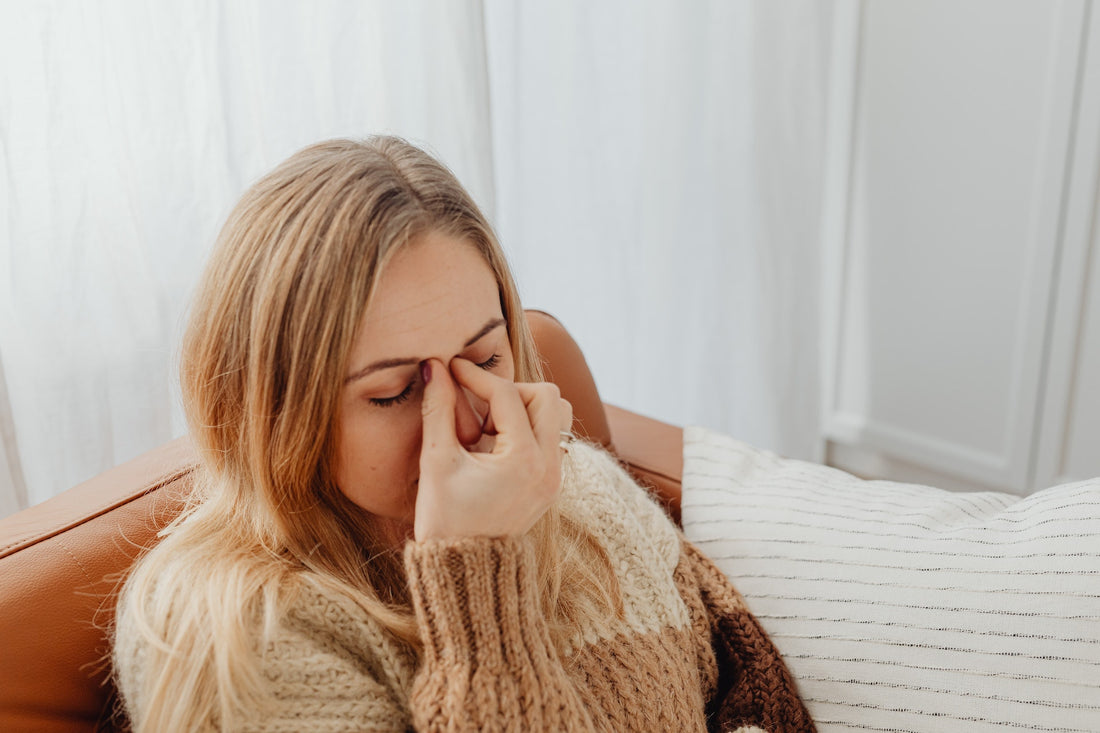 Woman Holding Her Nose Because of Sinus Headache
