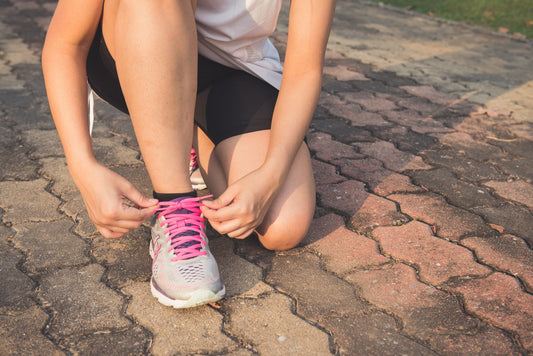 Woman lacing her running shoes