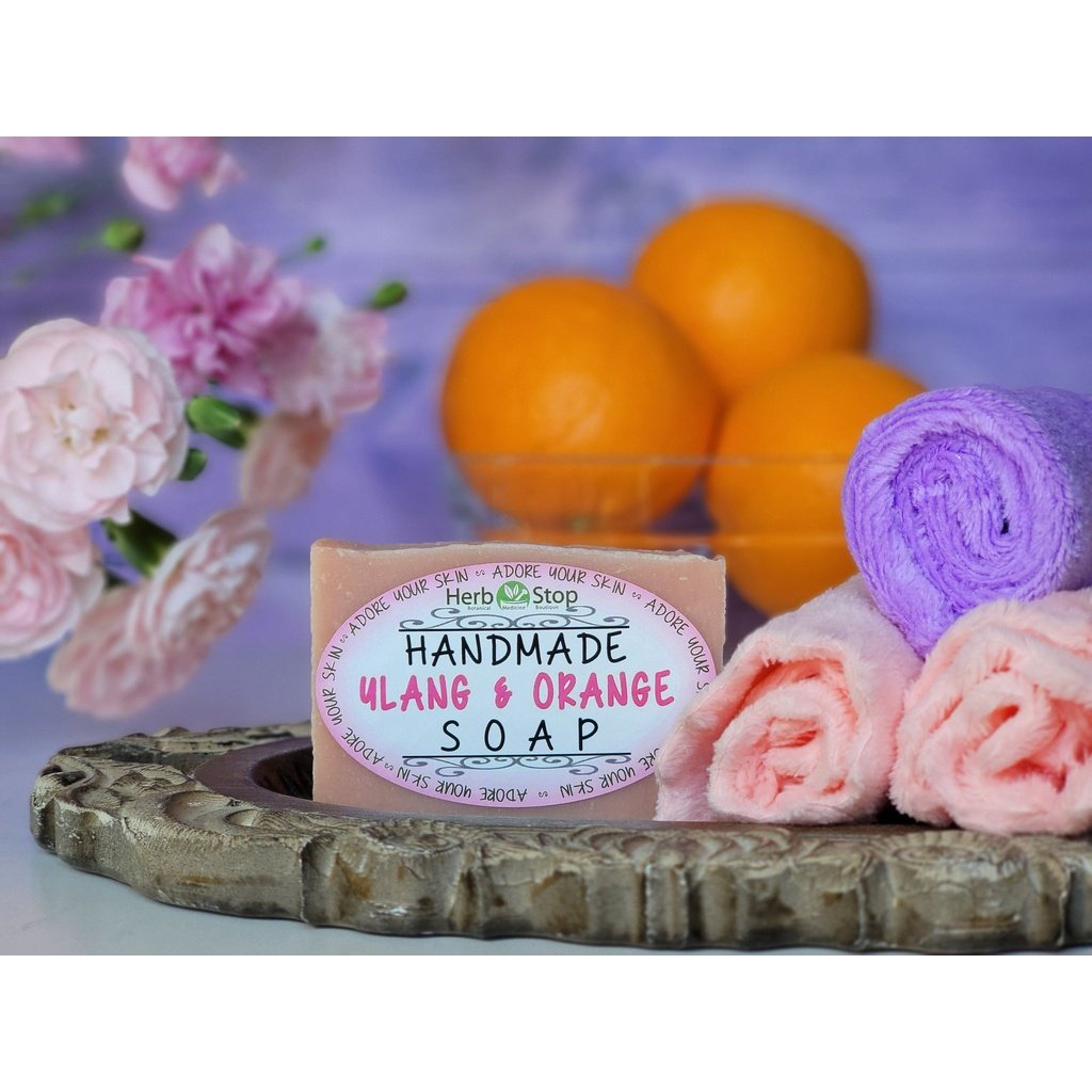 Ylang & Orange Soap on a tray with oranges and flowers in the background