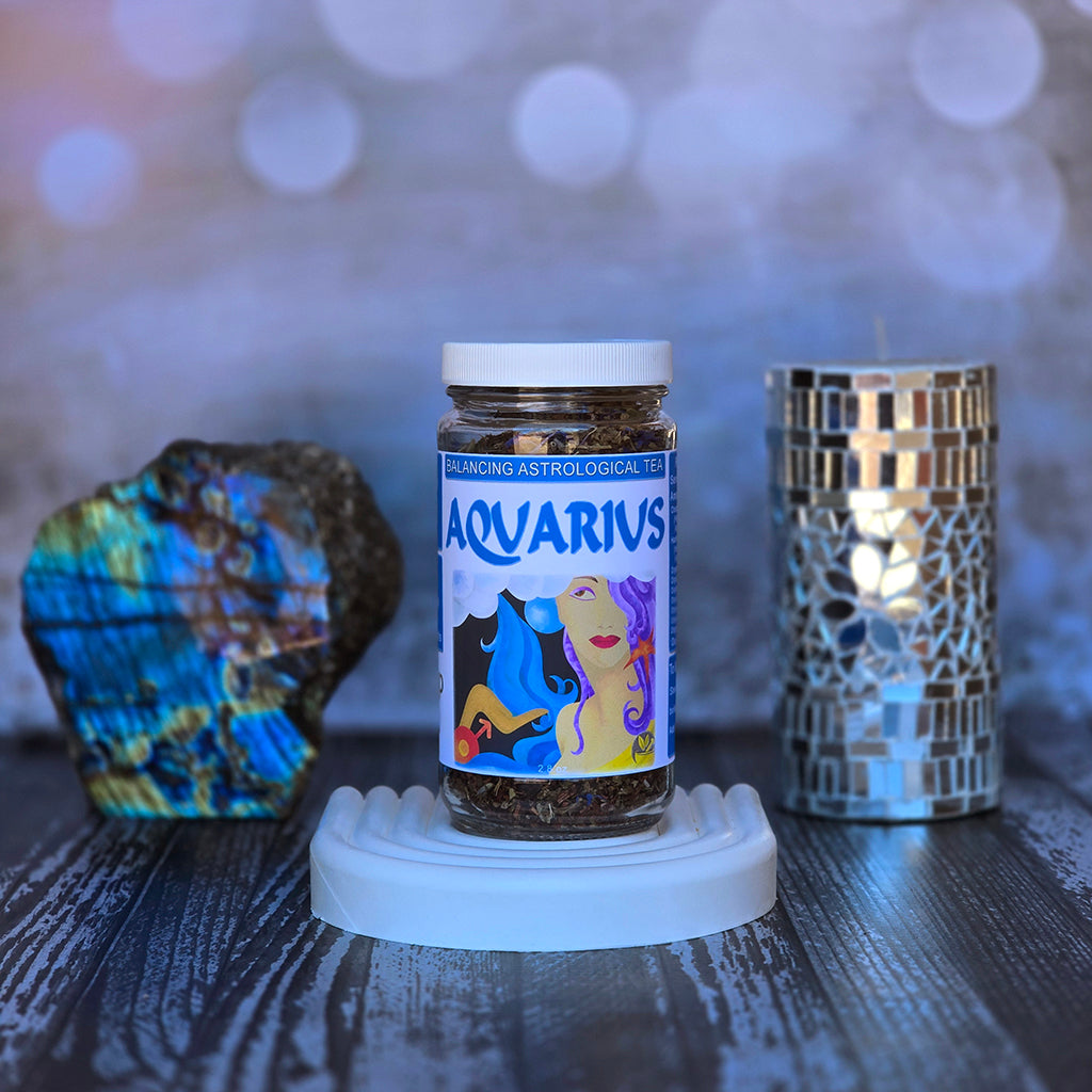 Jar of Aquarius astrological tea on a white surface with decorative elements.