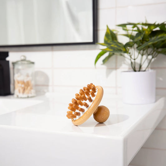 Bamboo scalp massager on bathroom counter