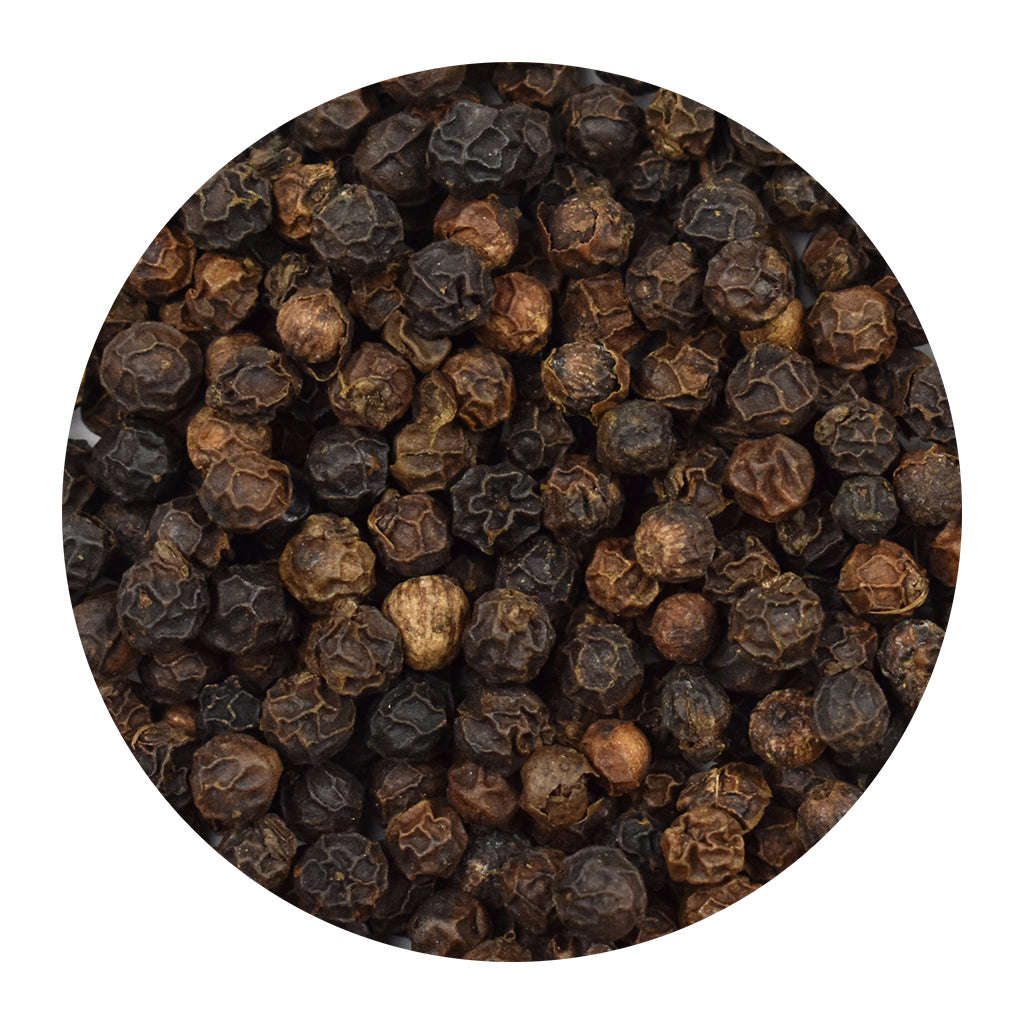 A circular close-up of whole black peppercorns, shown on a plain white background.