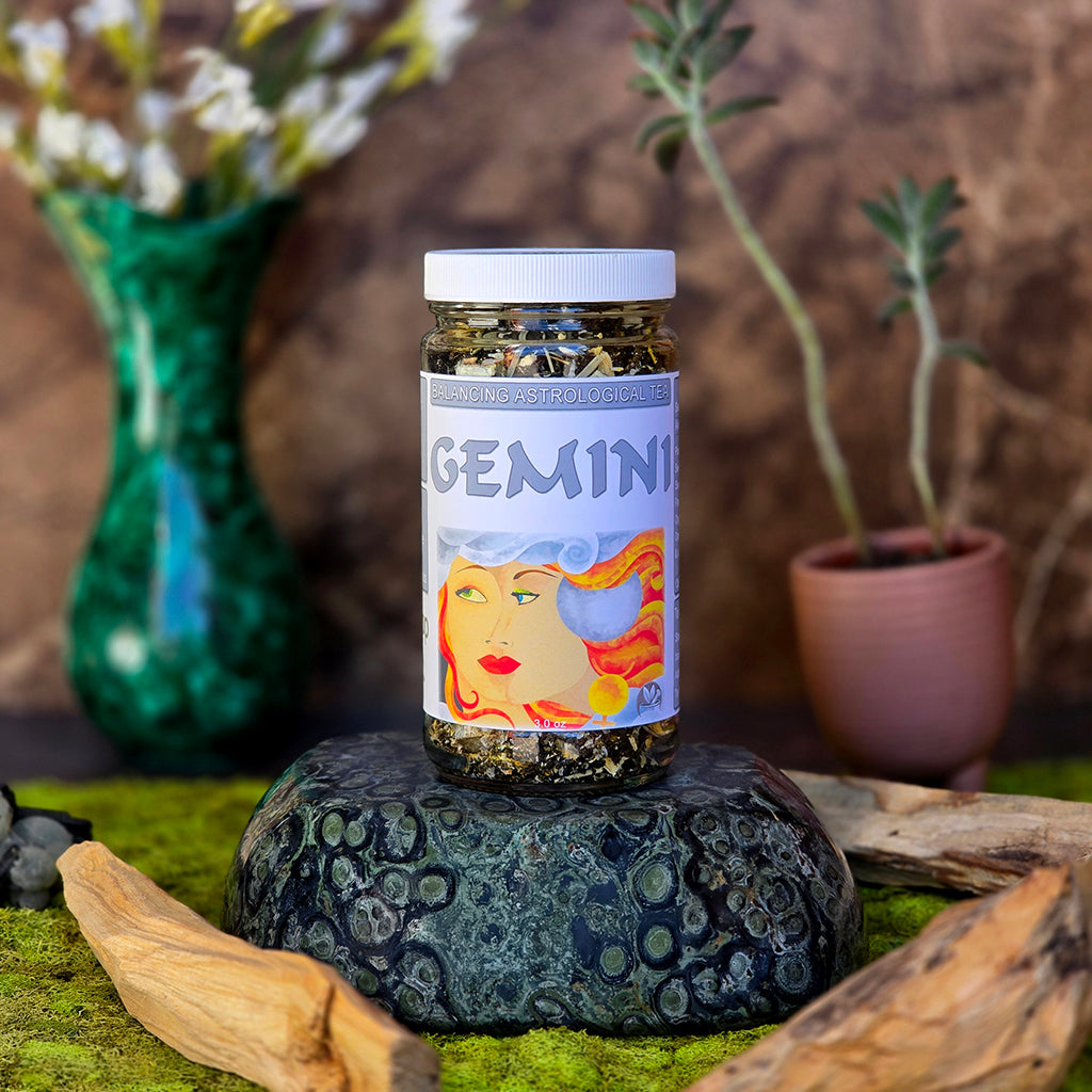 Jar of Gemini Astrological Tea on a stone with plants and natural elements in the background