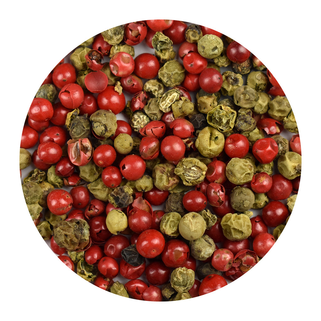 Close-up of pink and green peppercorns on a white background