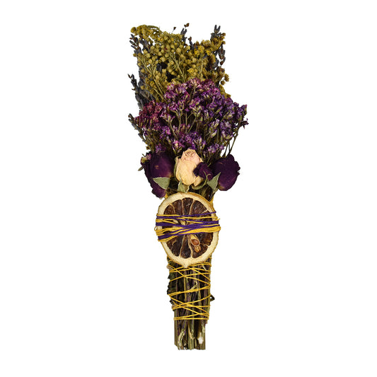 Handcrafted Lavender, Mint, and Lemon Smudge Stick with dried roses, purple flowers, and a dried lemon slice tied with yellow twine