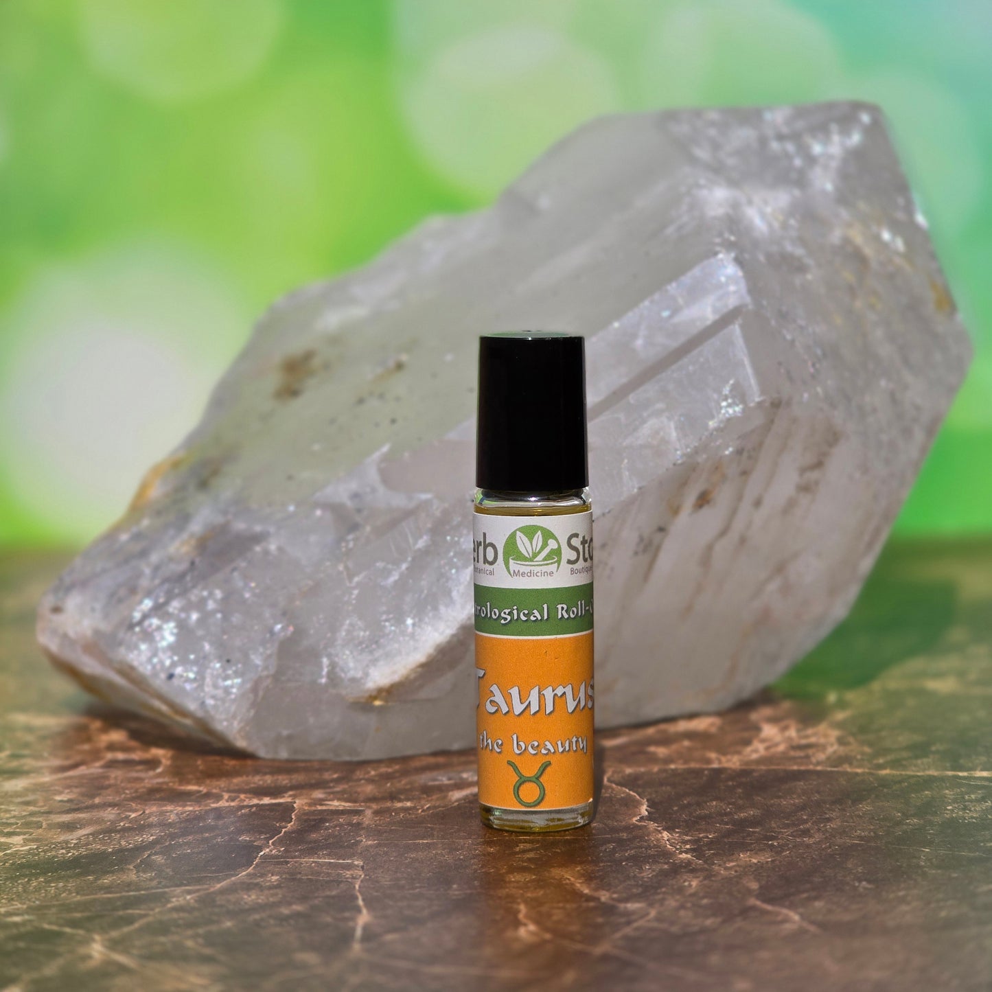 Taurus Aromatherapy Roll-On with a quartz crystal on a marble surface