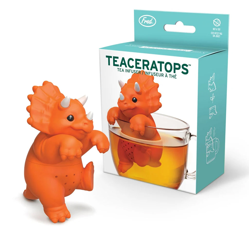 Orange dinosaur-shaped tea infuser with packaging on a white background