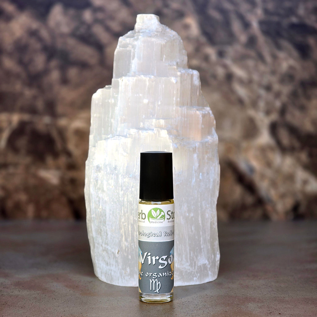 Virgo Aromatherapy Roll-On in front of a selenite crystal on a dark surface.