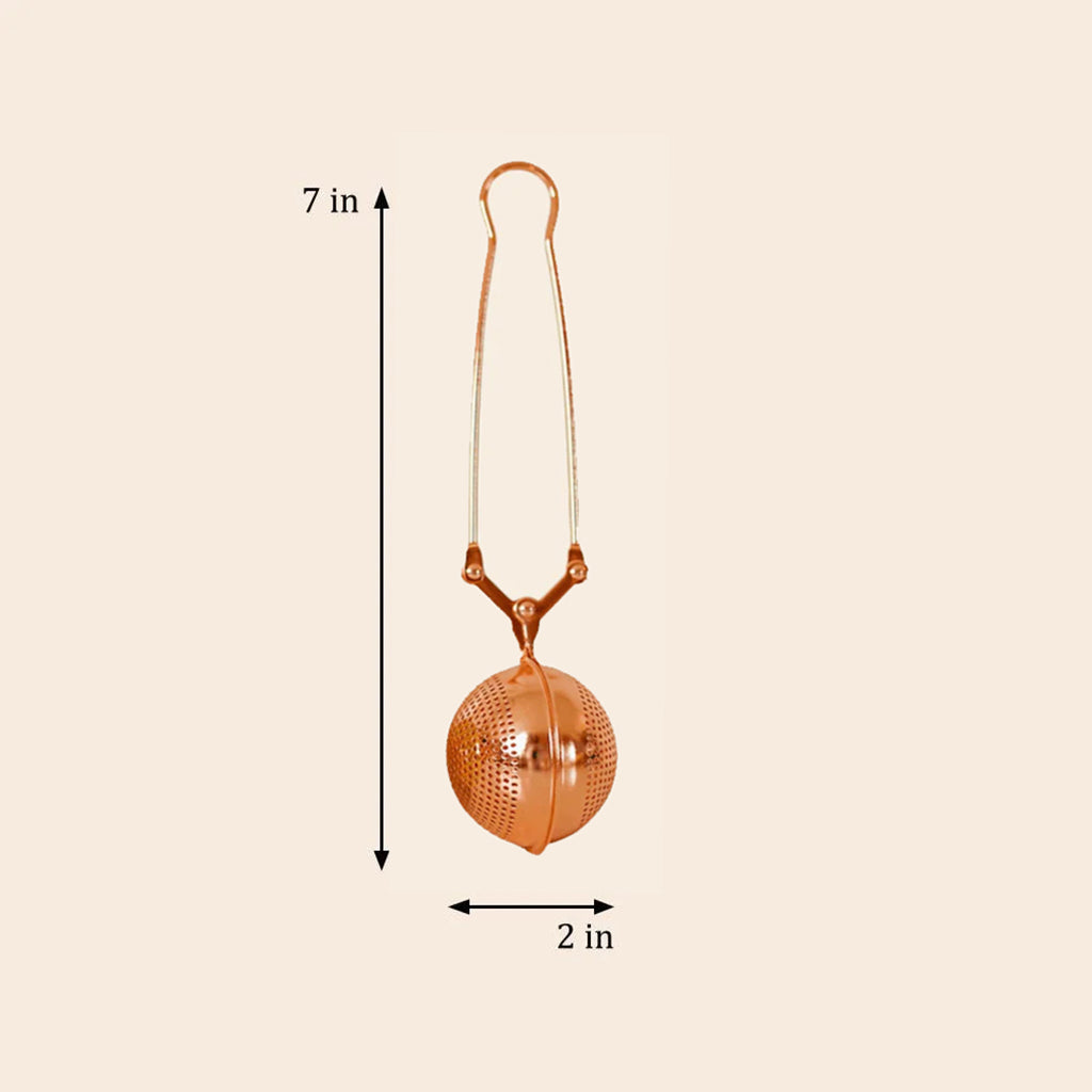Rose Gold tea ball with dimensions labeled on a beige background