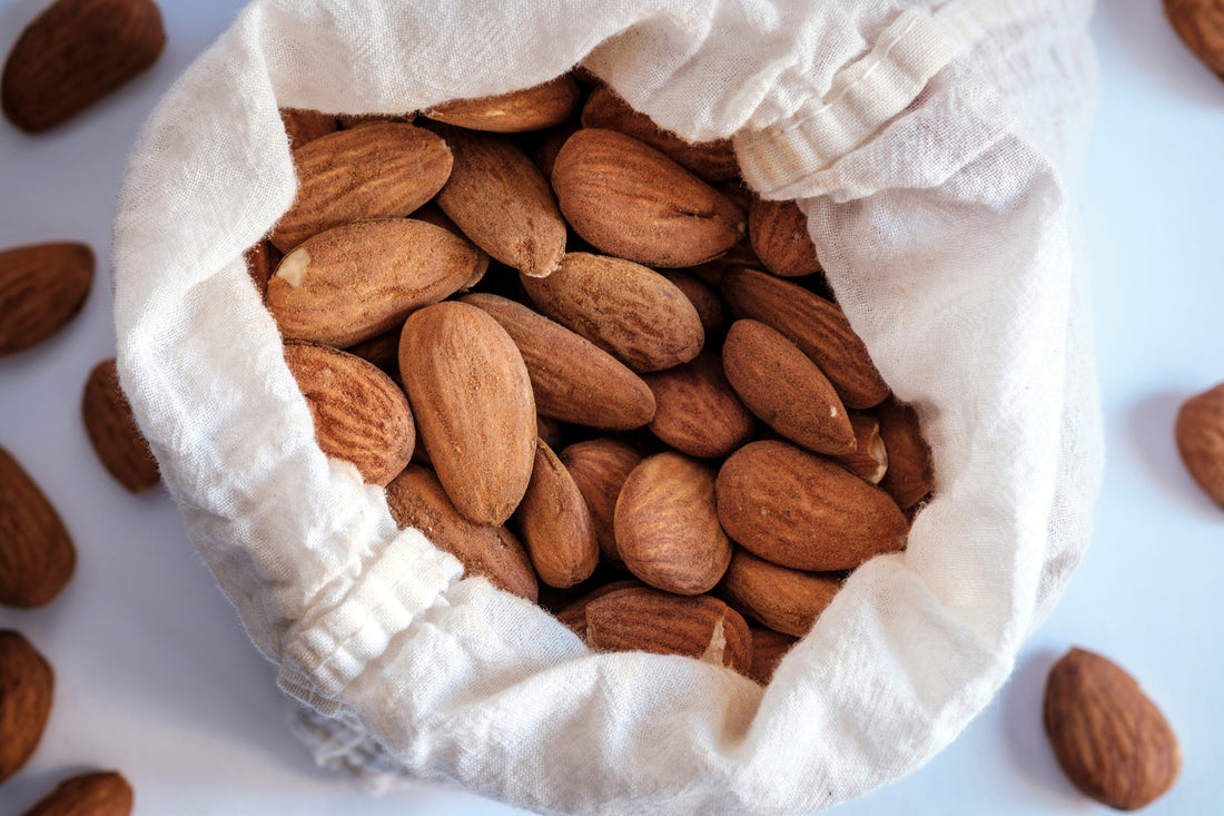 Raw almonds spilling from a burlap bag, highlighting nutrient-rich healthy fats, antioxidants, and plant-based wellness