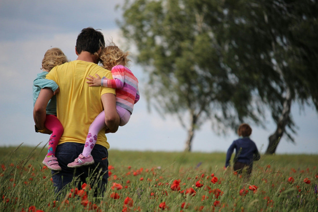 Father carrying his children outdoors, representing family, Father's Day, and thoughtful gifts for Dad