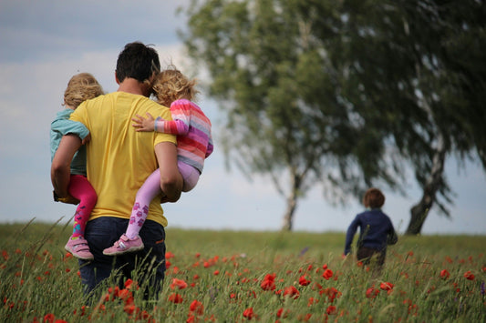Father carrying his children outdoors, representing family, Father's Day, and thoughtful gifts for Dad