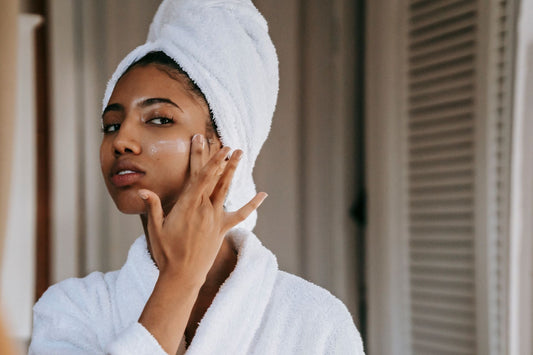 Woman applying collagen skincare cream to her face as part of her daily beauty routine