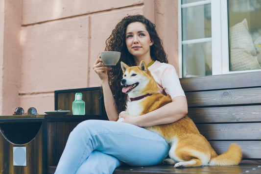 Woman relaxing outdoors with tea, supporting calm, natural energy without caffeine