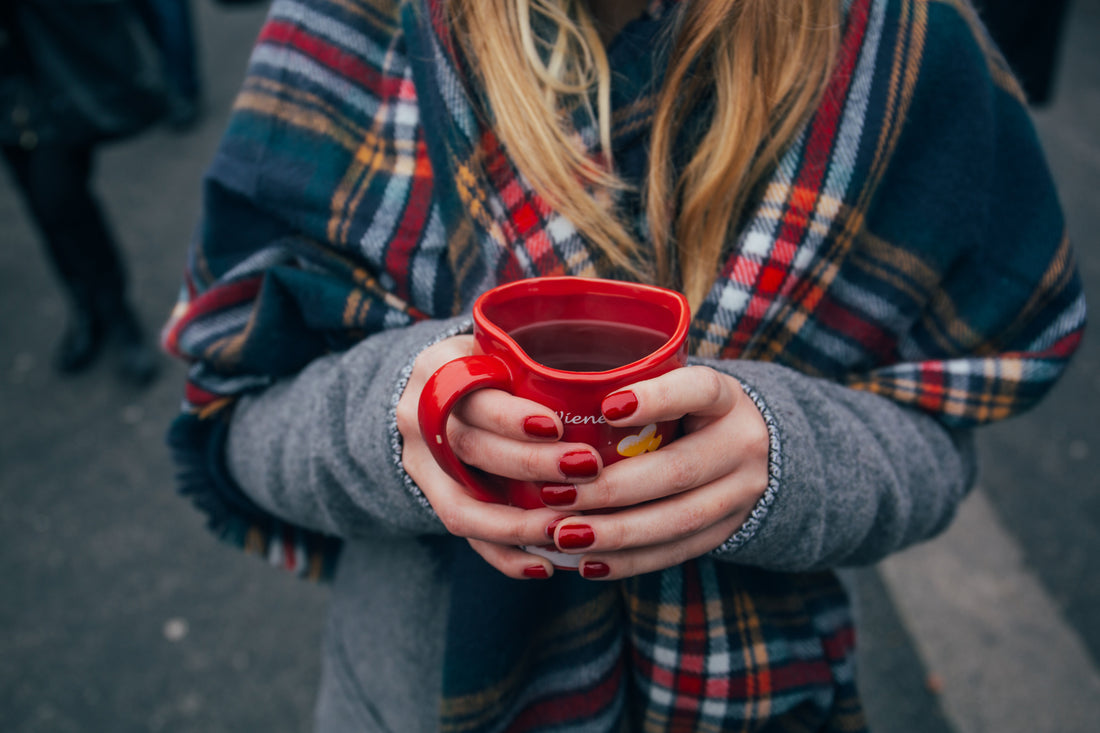 Woman holding hot tea mug