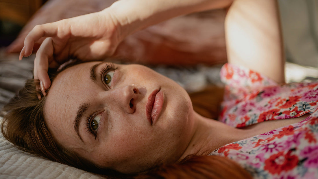 Person lying awake at night with racing thoughts, illustrating the effects of elevated nighttime cortisol and insomnia