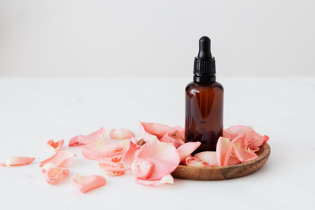 Brown bottle surrounded with rose petals