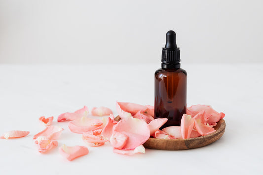 Brown bottle surrounded with rose petals