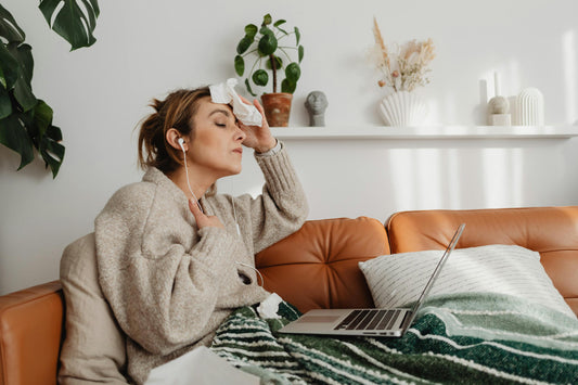 Woman experiencing hot flashes and sweating, illustrating menopause symptoms and herbal support for temperature regulation