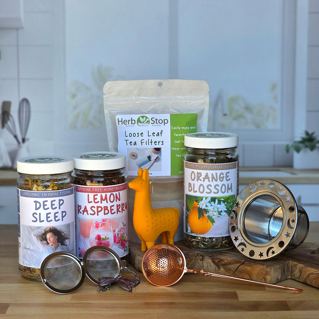 Loose Leaf Teas with tea accessories on a wooden surface with a kitchen background