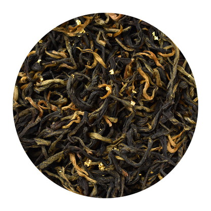 A circular close-up of 24 Karat Gold loose-leaf black tea leaves, showing gold pieces and dark brown rolled leaves with golden-brown tips, set against a solid white background.