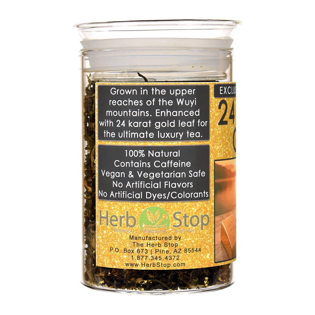 A jar of Herb Stop 24 Karat Gold luxury tea with a gold label, containing dark herbal tea leaves and edible gold, on a white background.