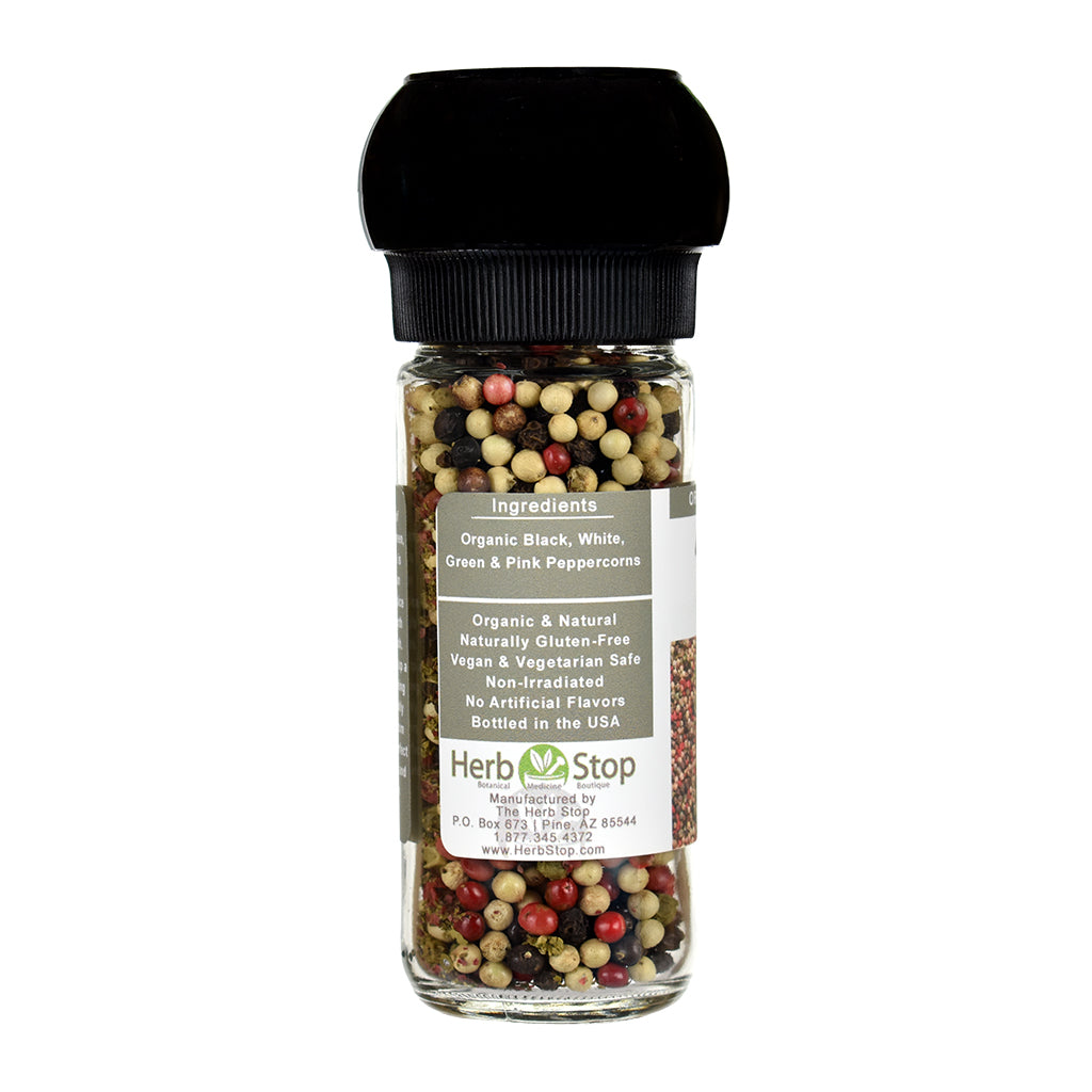 Bottle of 4 peppercorns blend with a black grinder lid on a white background
