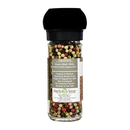 Bottle of 4 peppercorns blend with a black grinder lid on a white background