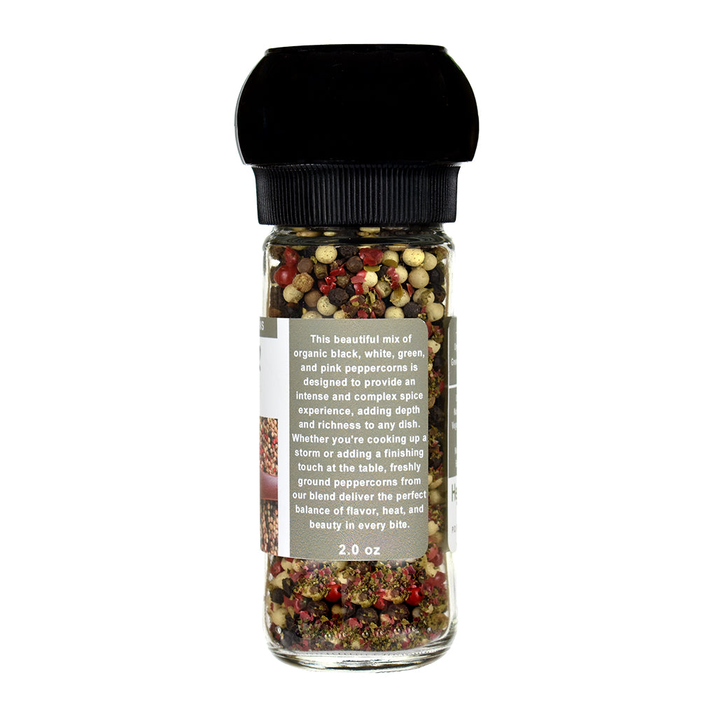 Spice grinder with colorful peppercorns on a white background