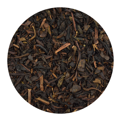 Close-up of Almond Oolong tea leaves on a white background