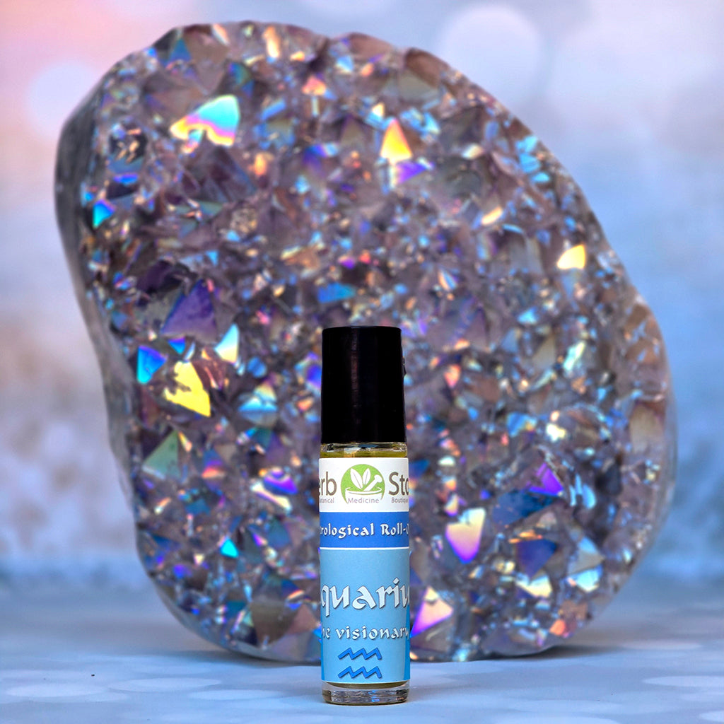 Aquarius Aromatherapy Roll-on bottle in front of a Aqua Aura Quartz crystal