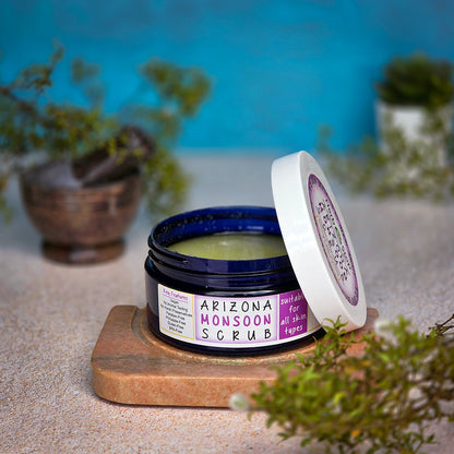 Jar of Arizona Monsoon Scrub on desert sand with chaparral in the background.