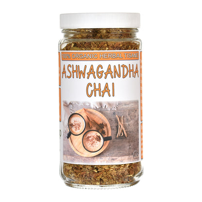 A glass jar of Ashwagandha Chai herbal tea with a white lid and a white label featuring orange text and an illustration of cups on a wooden board, set against a plain white background.