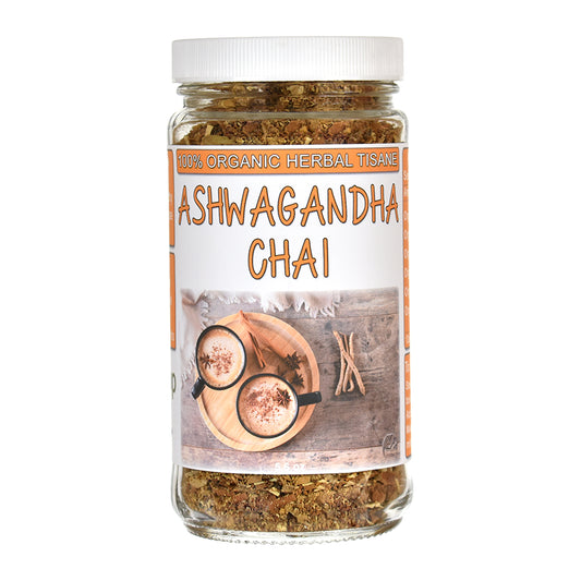 A glass jar of Ashwagandha Chai herbal tea with a white lid and a white label featuring orange text and an illustration of cups on a wooden board, set against a plain white background.