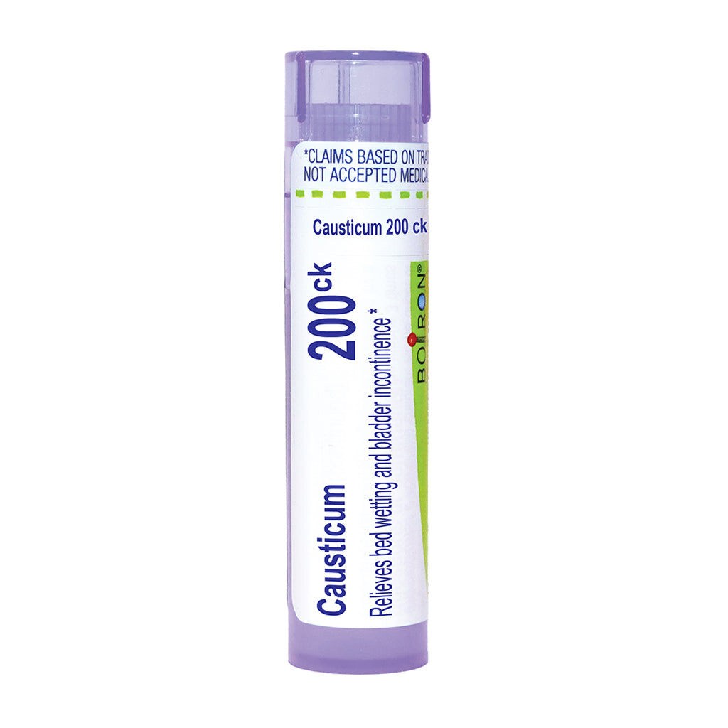 A single tube of Boiron Causticum 200ck bed wetting and bladder incontinence treatment, featuring a white and light purple design with blue and green text and accents, set against a plain white background.