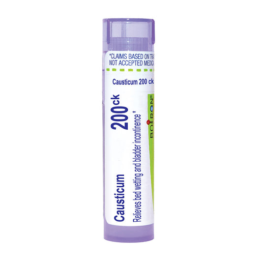 A single tube of Boiron Causticum 200ck bed wetting and bladder incontinence treatment, featuring a white and light purple design with blue and green text and accents, set against a plain white background.