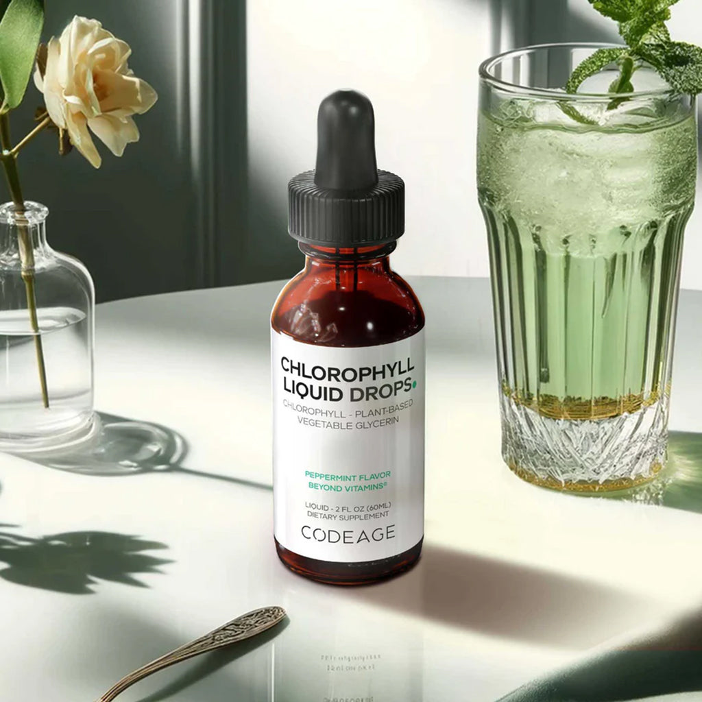Bottle of Chlorophyll Liquid Drops by Codeage next to a glass of green drink on a light surface.