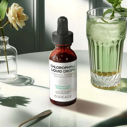 Bottle of Chlorophyll Liquid Drops by Codeage next to a glass of green drink on a light surface.