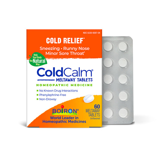 ColdCalm Meltaway Tablets homeopathic medicine packaging box in orange, white, and blue, shown next to a silver-gray blister pack containing 60 white round tablets on a white background.