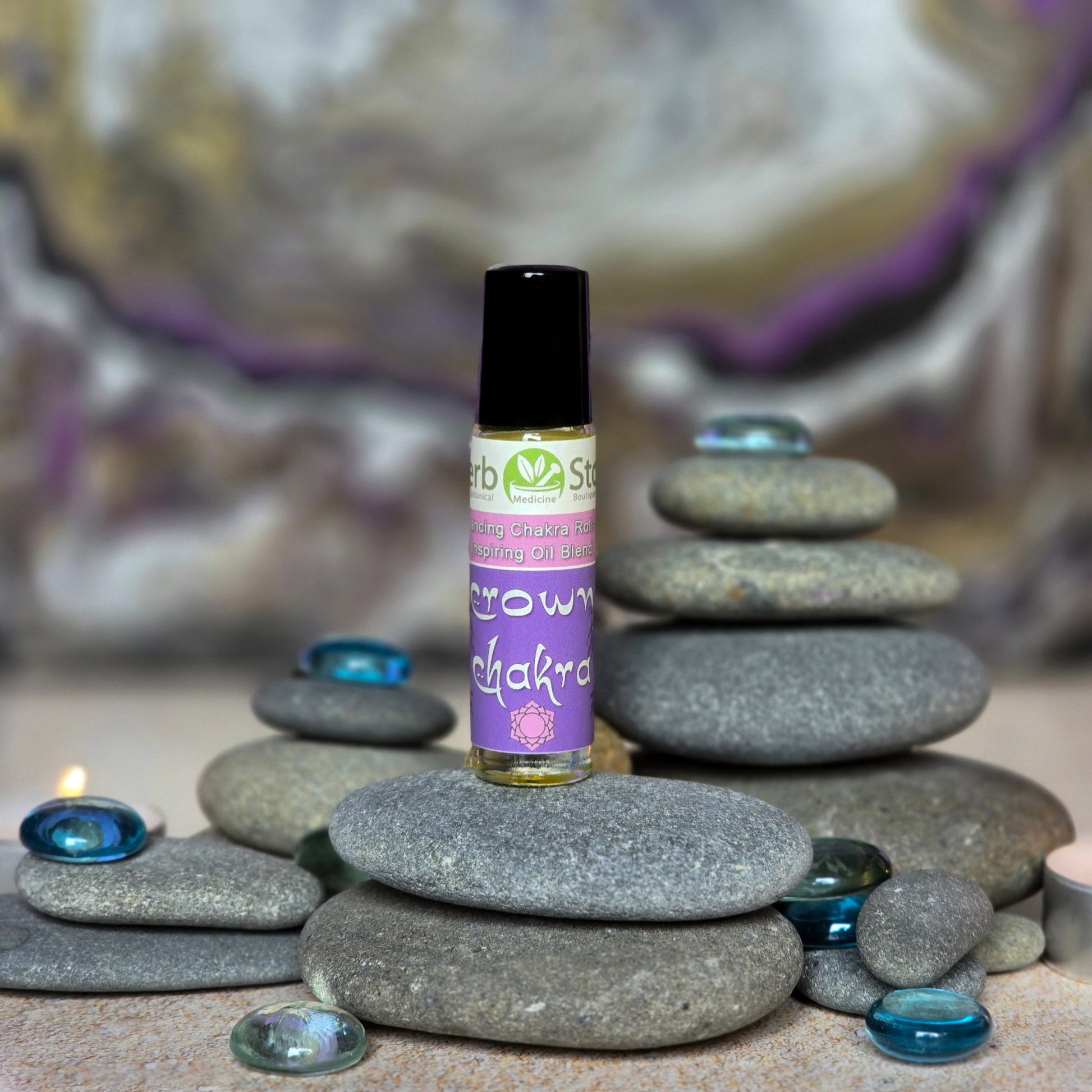 Crown Chakra Aromatherapy Roll-On on pebbles