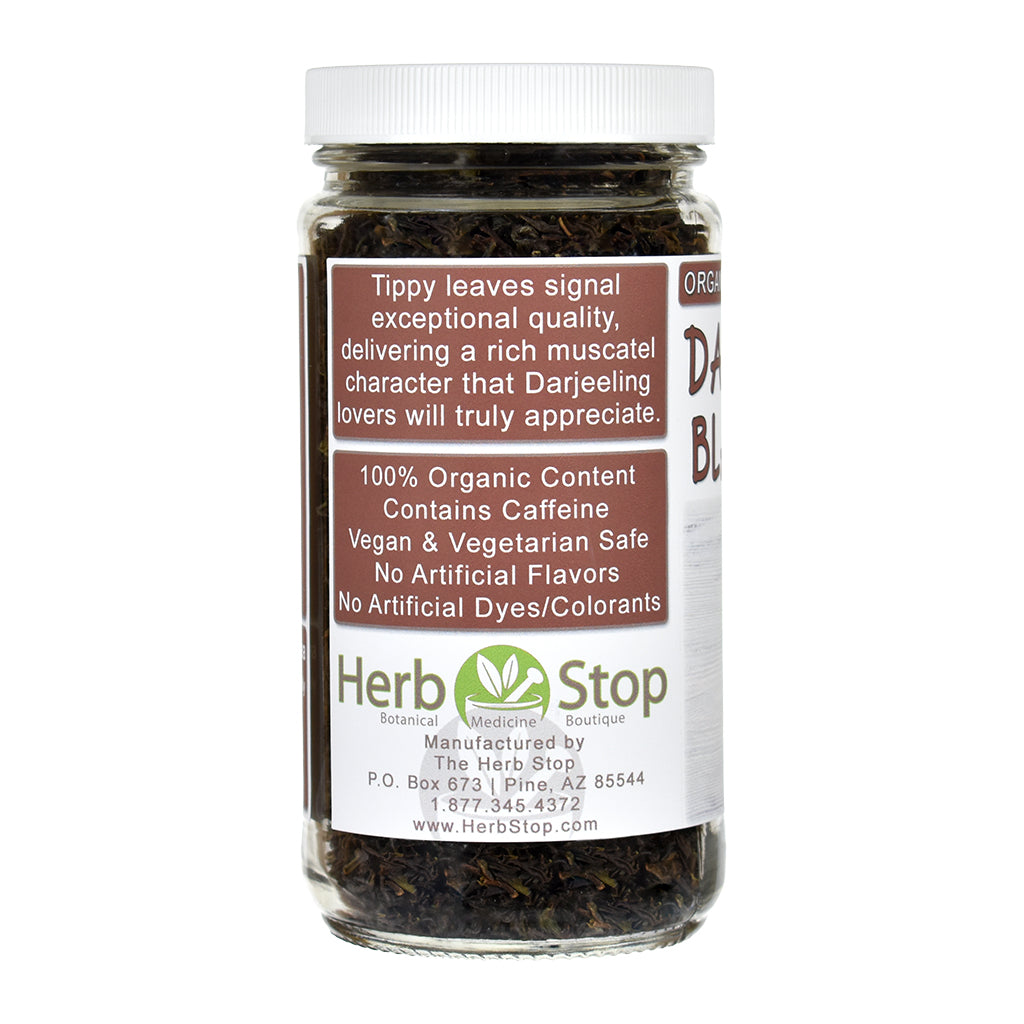 Jar of Darjeeling black tea leaves with Herb Stop label on a white background