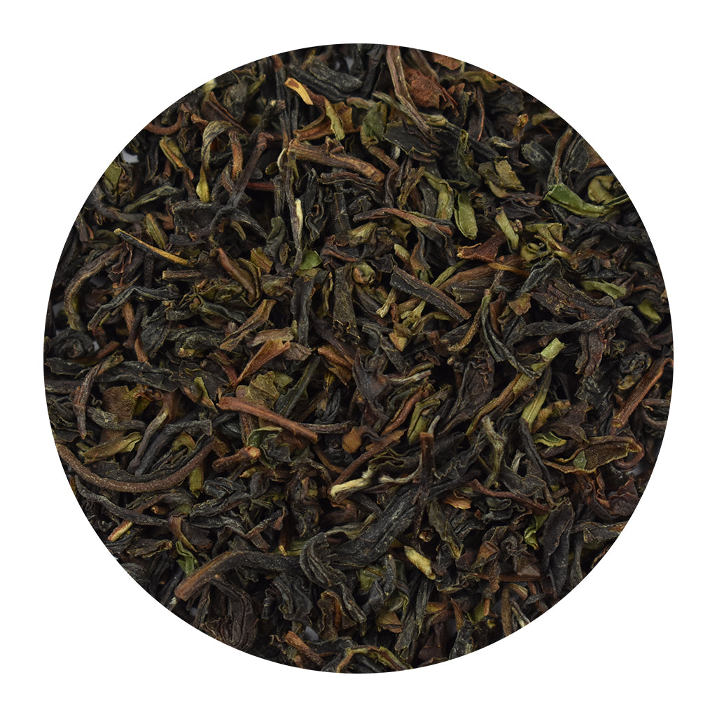 Close-up of Darjeeling tea leaves on a white background