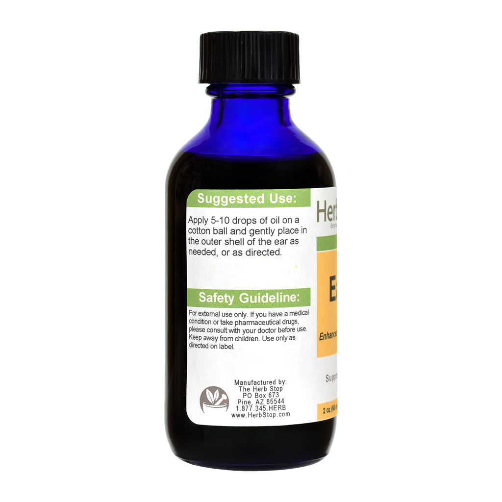 Blue glass bottle of Herb Stop's Ear Oil with a label on a white background