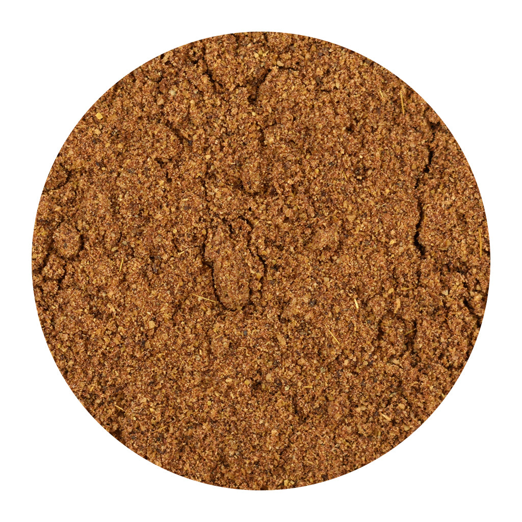 A circular close-up of Garam Masala seasoning on a plain white background.